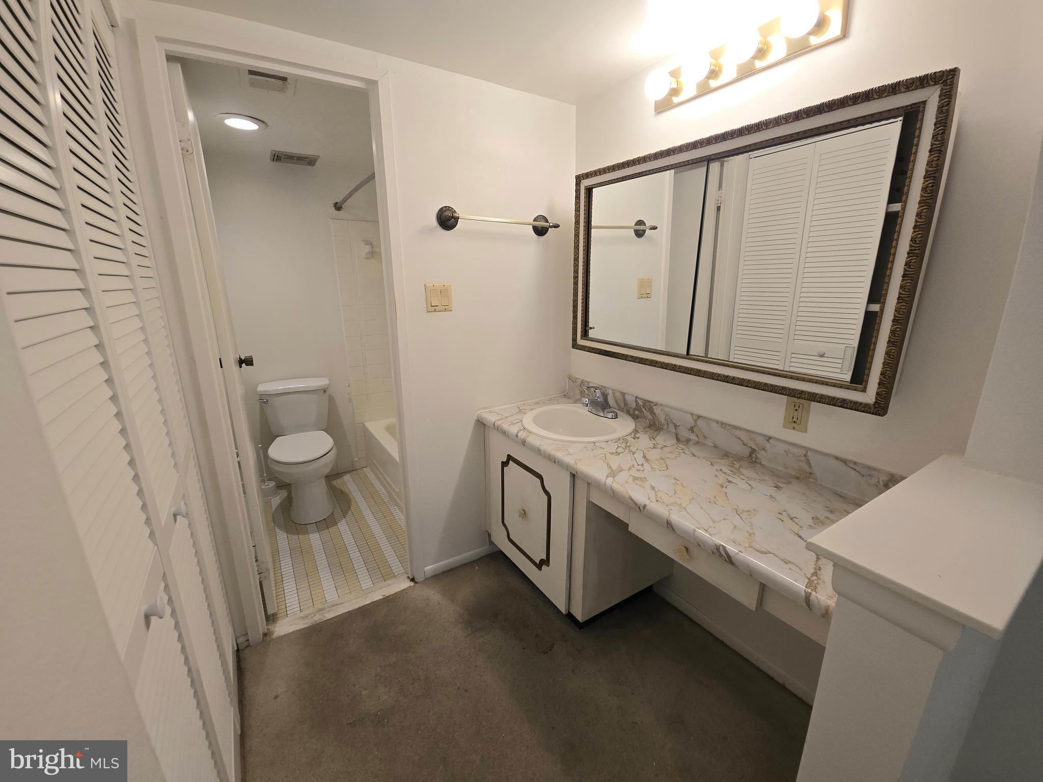 5026 North Convent Lane, Unit J Philadelphia, PA 19114 - Photo 15 of 41 a bathroom with a granite countertop sink and a mirror