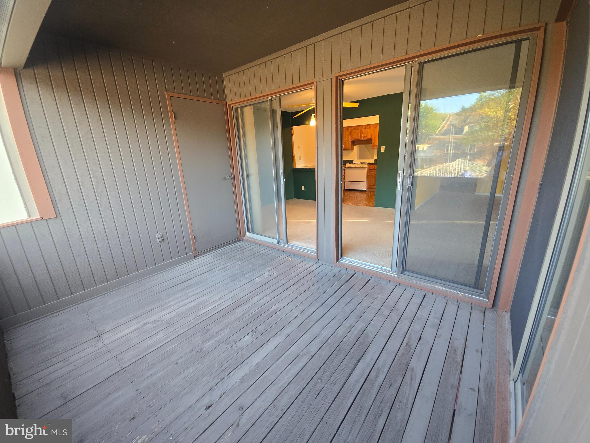 5026 North Convent Lane, Unit J Philadelphia, PA 19114 - Photo 18 of 41 a view of an empty room with wooden floor and a window