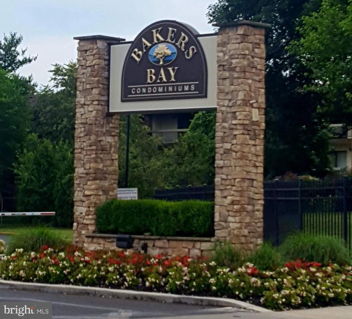 5026 North Convent Lane, Unit J Philadelphia, PA 19114 - Photo 22 of 41 a sign that is sitting in front of flowers