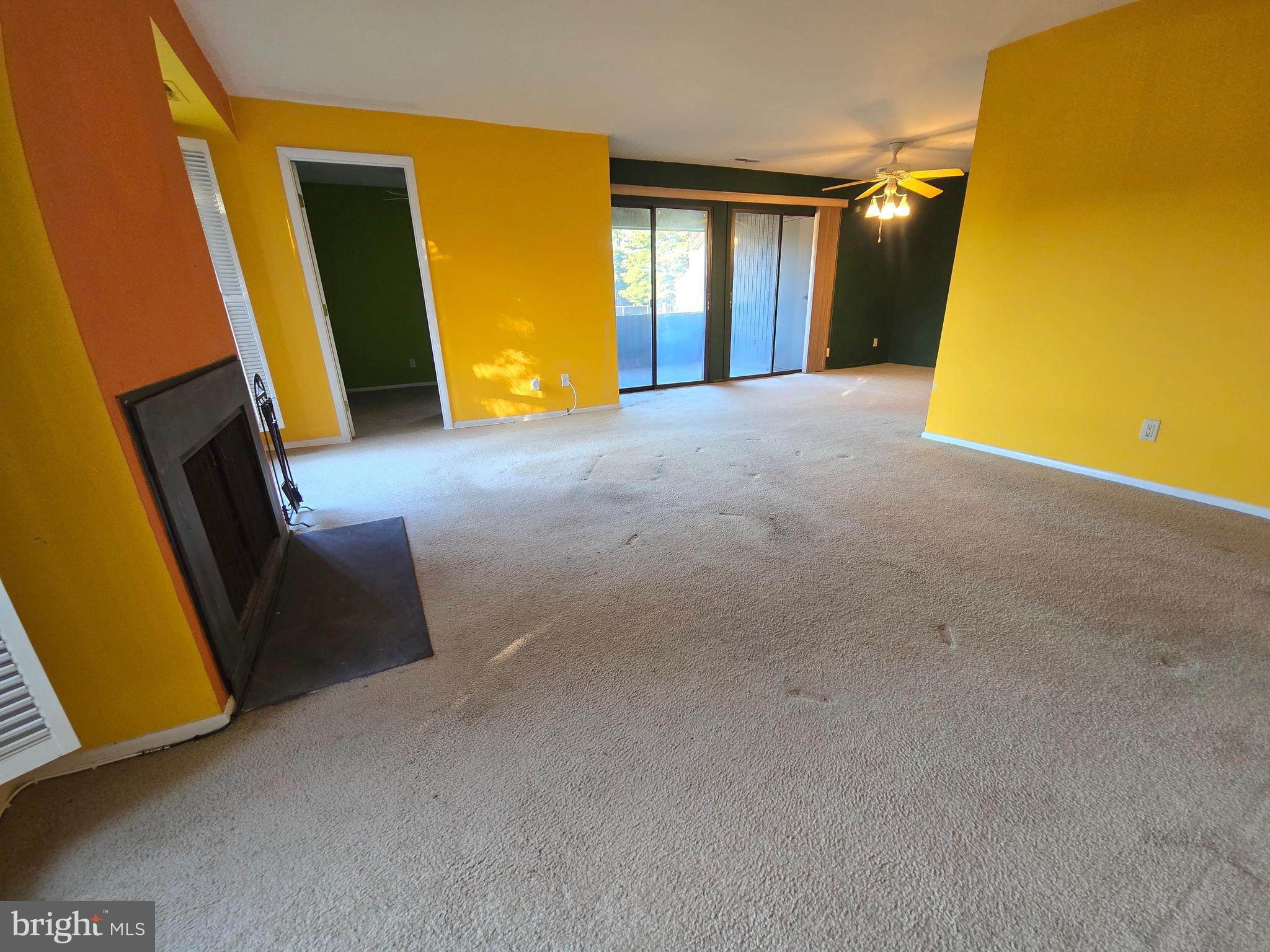 5026 North Convent Lane, Unit J Philadelphia, PA 19114 - Photo 6 of 41 a view of an empty room with a fireplace