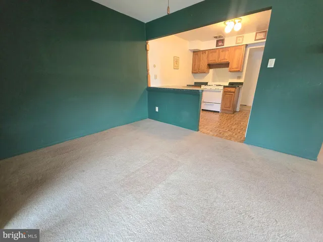 a view of a kitchen with a sink and a refrigerator