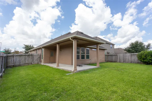 a view of a house with wooden fence