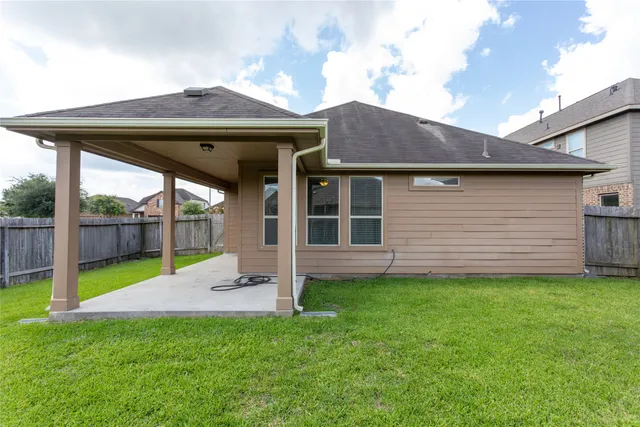 a view of a backyard with a barbeque grill and a garden