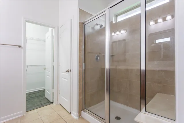 a bathroom with a glass shower door