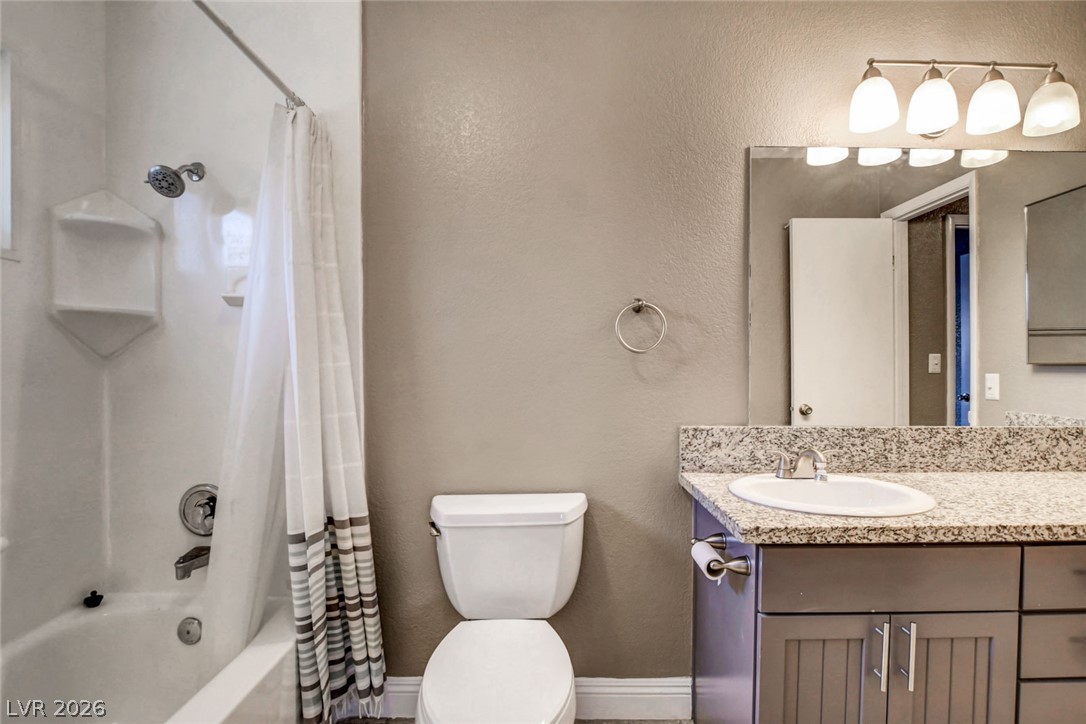4367 South Mojave Road Las Vegas, NV 89121 - Photo 40 of 53 Modern bathroom featuring a pristine white bathtub, shower, and a stylish vanity with ample counter space.