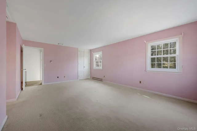 a spacious bedroom with a bed and glass door
