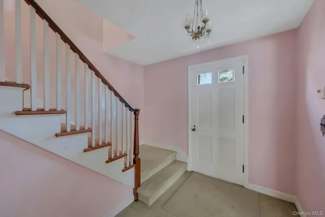 a view of entryway with stairs and wooden floor