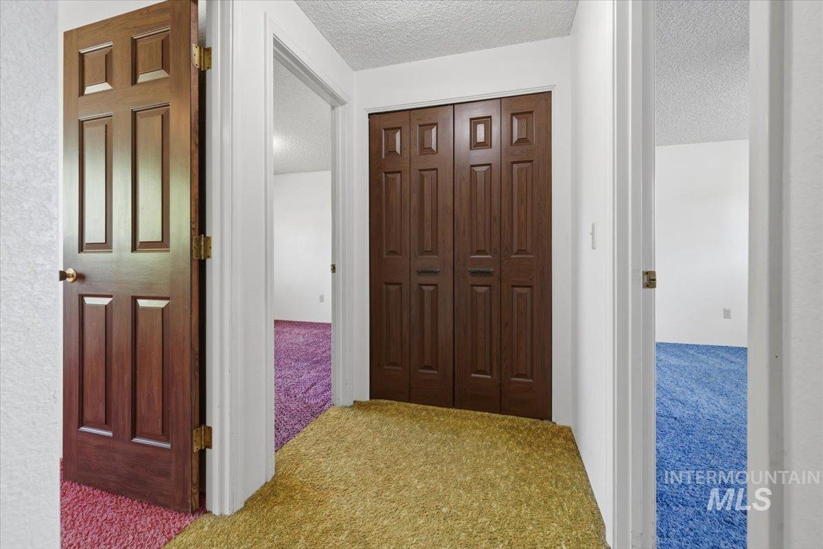 1311 North Middleton Road Nampa, ID 83651 - Photo 23 of 49 Interior hallway with dark wood-finish doors and textured white walls