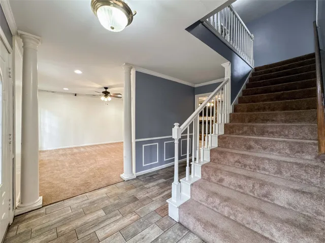 a view of entryway and hall with wooden floor