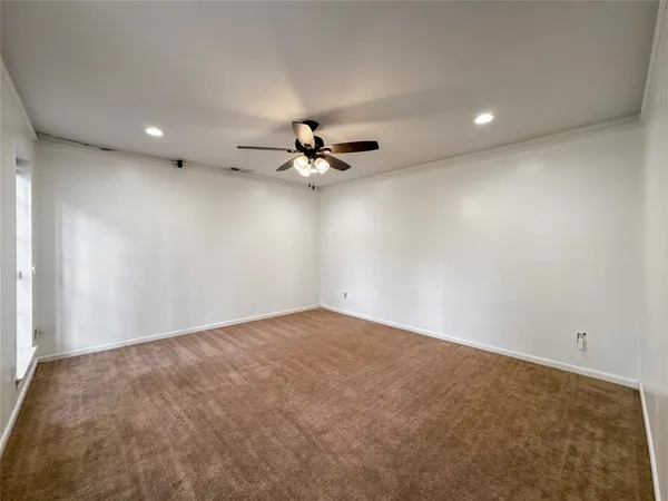 a view of a livingroom with a ceiling fan and carpet