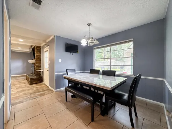 a view of a dining room with furniture and window