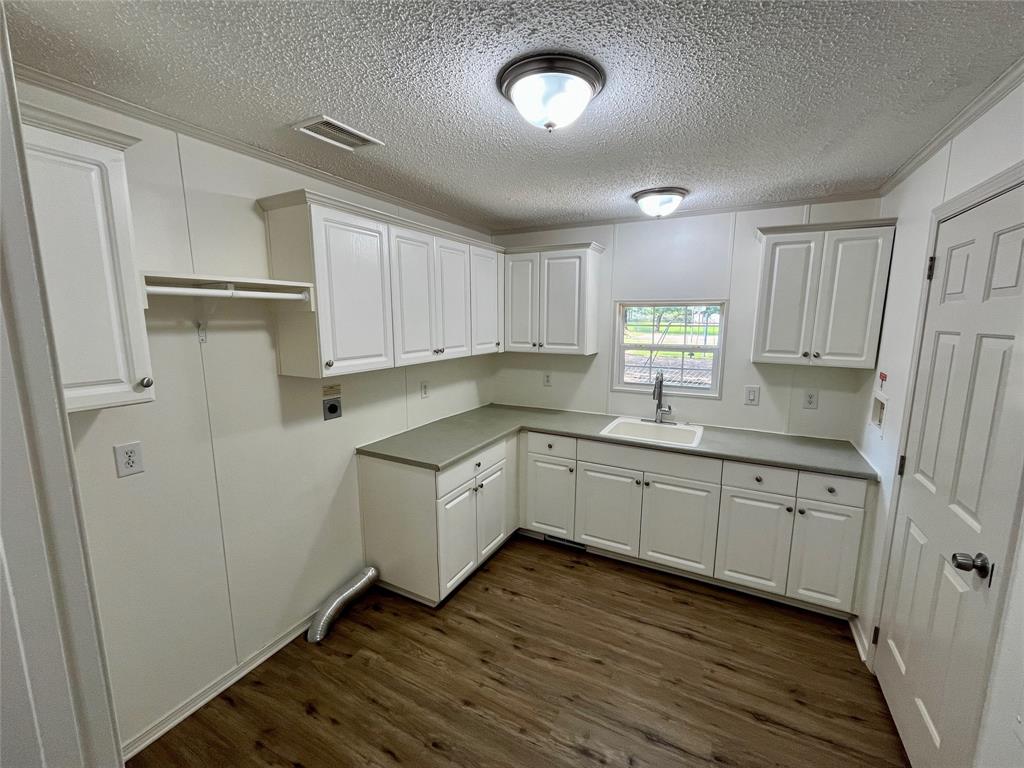 6913 Rice Road Shreveport, LA 71129 - Photo 23 of 26 a kitchen with granite countertop white cabinets and white appliances