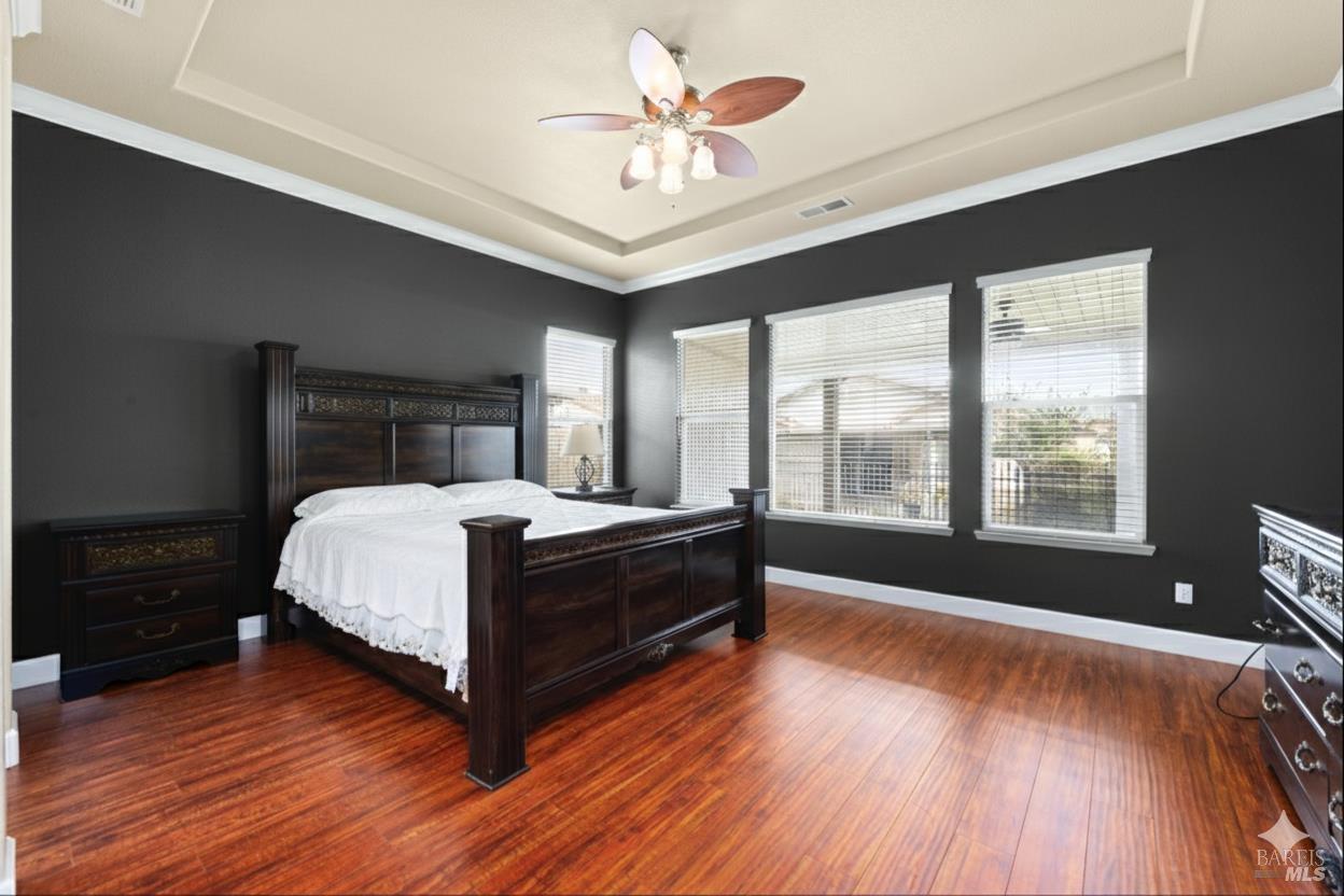 210 Southern Hills Drive Rio Vista, CA 94571 - Photo 13 of 52 a bedroom with a bed and a large window with wooden floor
