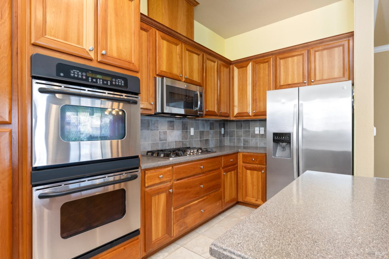 210 Southern Hills Drive Rio Vista, CA 94571 - Photo 27 of 52 a kitchen with granite countertop a refrigerator stove and microwave