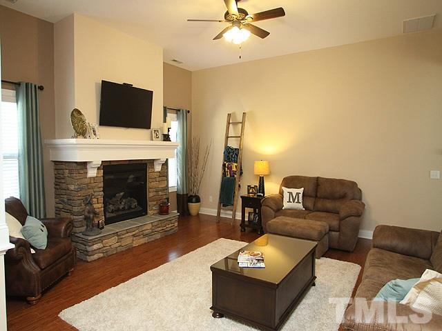 4429 Glengrove Road Raleigh, NC 27616 - Photo 3 of 13 a living room with furniture and a fireplace