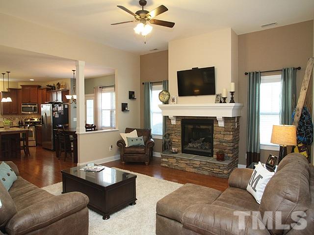 4429 Glengrove Road Raleigh, NC 27616 - Photo 4 of 13 a living room with furniture a flat screen tv and a fireplace