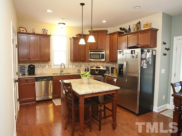 4429 Glengrove Road Raleigh, NC 27616 - Photo 5 of 13 a kitchen with stainless steel appliances granite countertop a refrigerator a sink a stove and a wooden floors