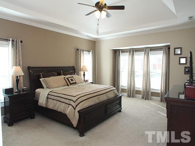 4429 Glengrove Road Raleigh, NC 27616 - Photo 7 of 13 a spacious bedroom with a bed and a chandelier