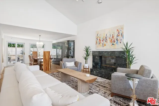 a view of a a dining room with furniture window and wooden floor