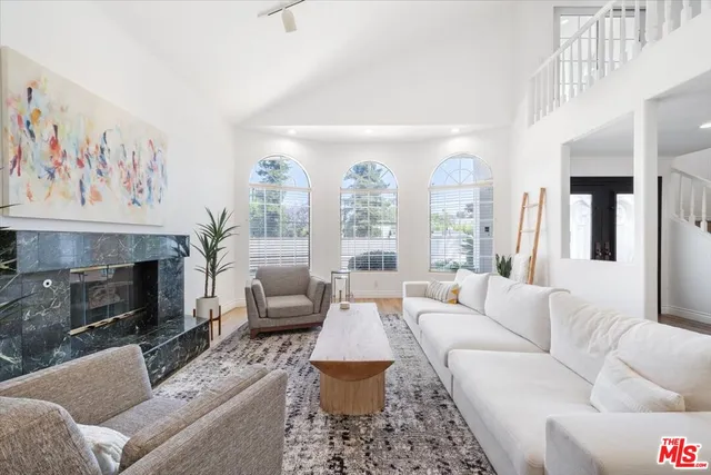 a view of a patio with table and chairs under an umbrella