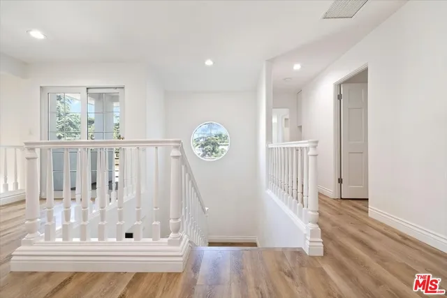 a view of a livingroom with a flat screen tv wooden floor and a fireplace