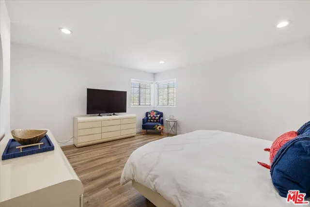 a living room with stainless steel appliances kitchen island furniture and wooden floor