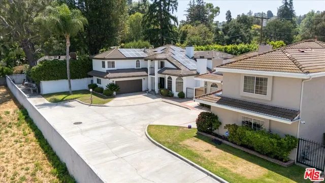 a living room with furniture and view of kitchen