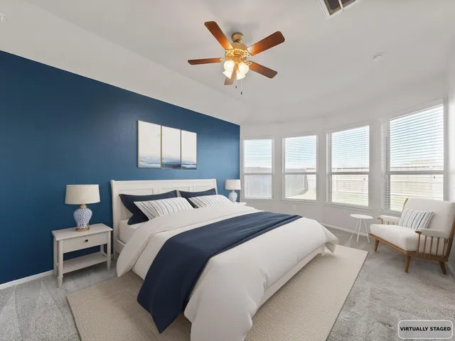 a bedroom with a bed a window and a couch