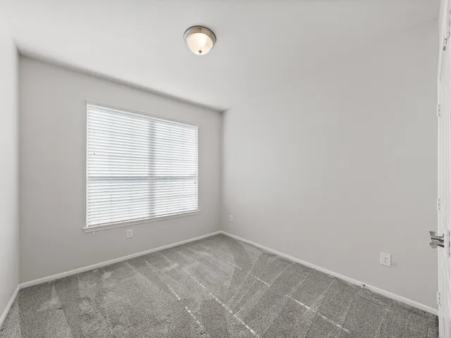 a bathroom with a granite countertop sink a toilet and a mirror