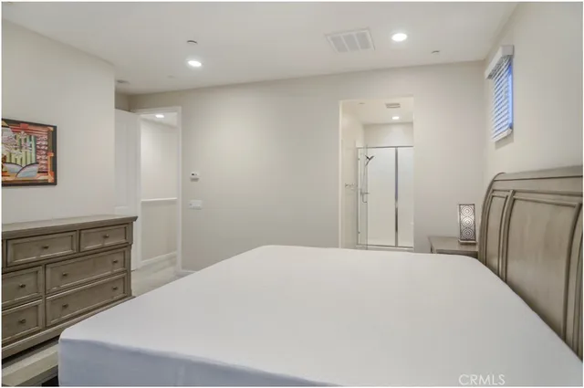 a bathroom with a shower sink vanity and mirror