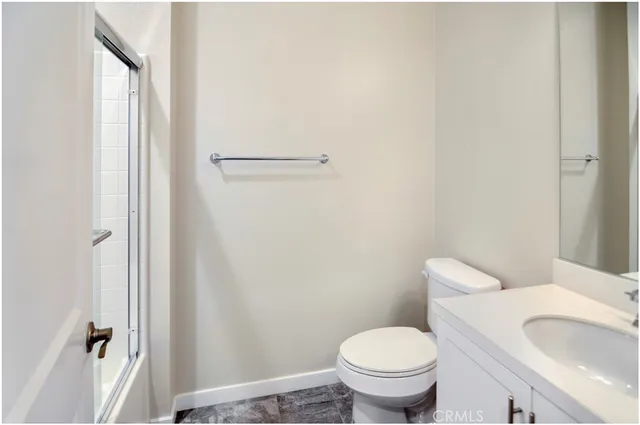 a white toilet sitting next to a bathroom sink