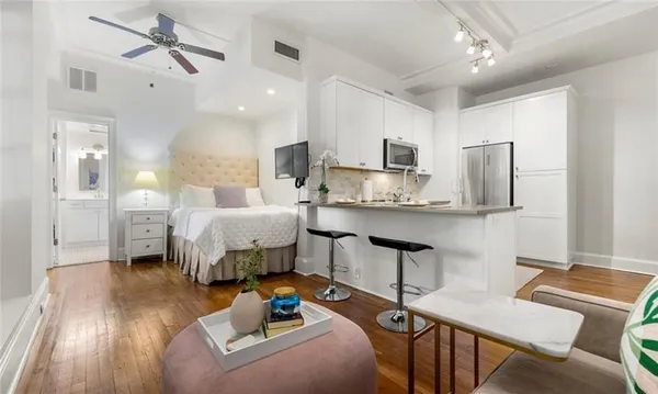 a bedroom with a bed window and table chair