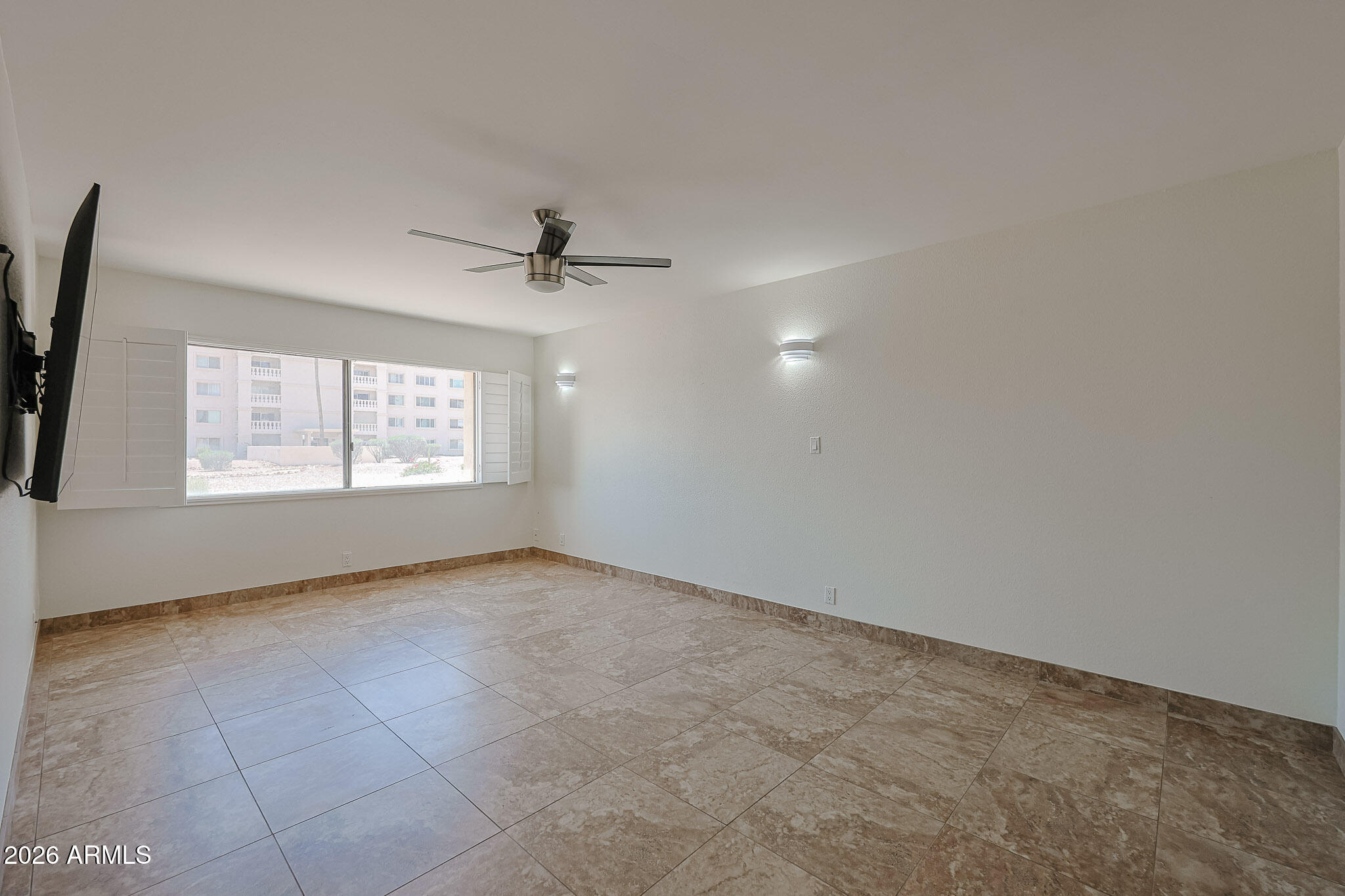 7920 East Camelback Road, Unit 111 Scottsdale, AZ 85251 - Photo 12 of 32 an empty room with windows and fan