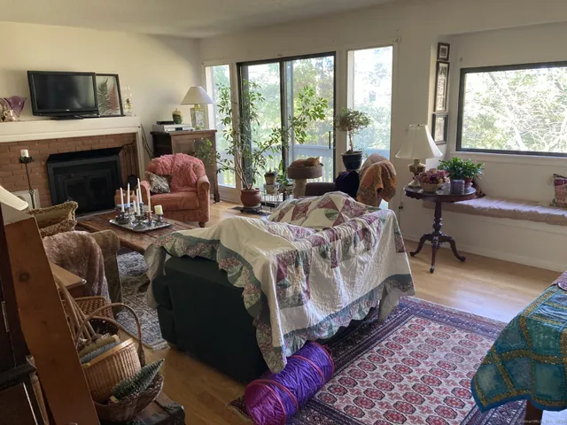 a spacious bedroom with a bed a flat screen tv and a large window