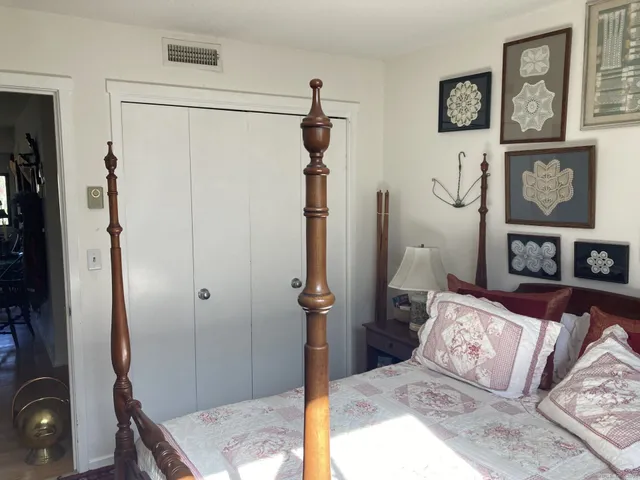 a bedroom with a bed and a mirror