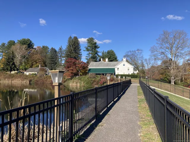a front view of a house with a yard and outdoor seating