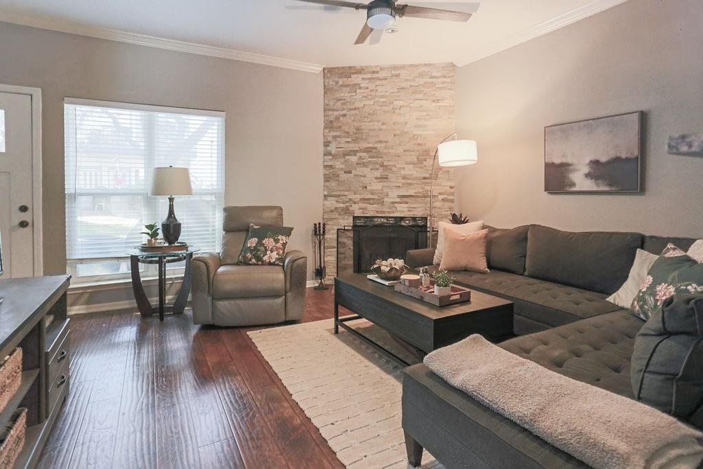 1307 Kinney Avenue, Unit 121 Austin, TX 78704 - Photo 2 of 12 a living room with furniture and a fireplace
