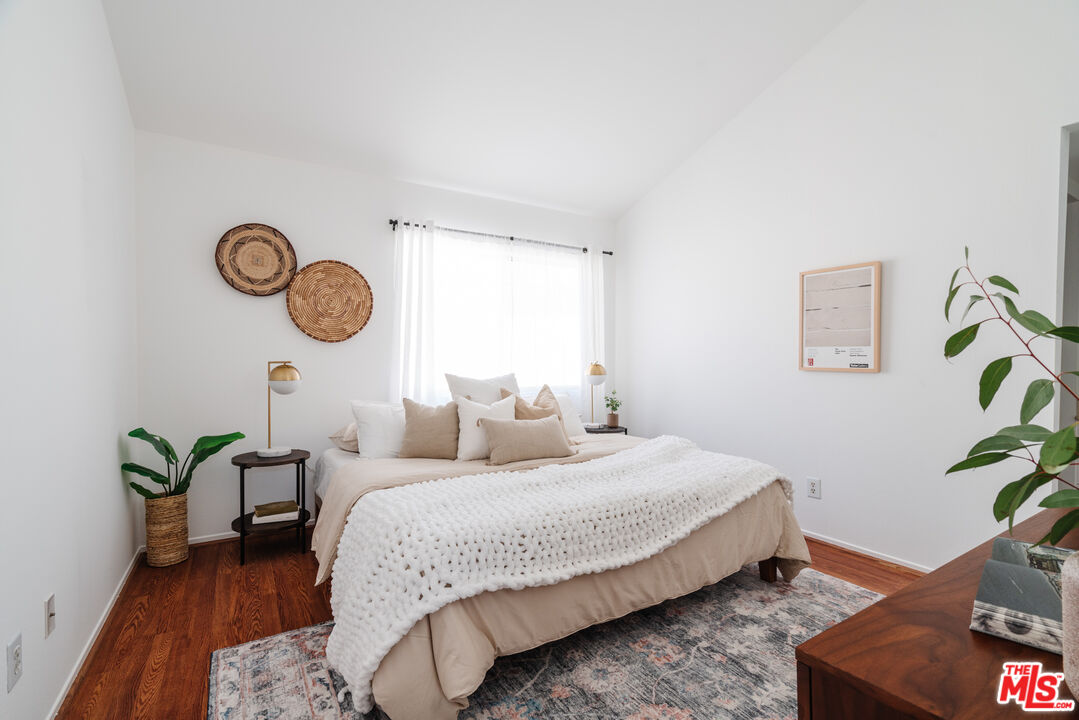 11106 Arminta Street, Unit 4 Sun Valley, CA 91352 - Photo 12 of 22 a bedroom with bed and a potted plant