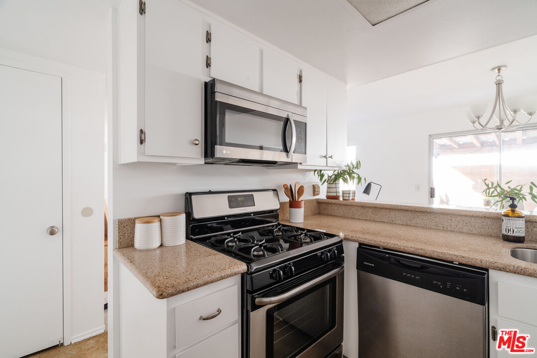 11106 Arminta Street, Unit 4 Sun Valley, CA 91352 - Photo 9 of 22 a kitchen with granite countertop cabinets stainless steel appliances and a sink