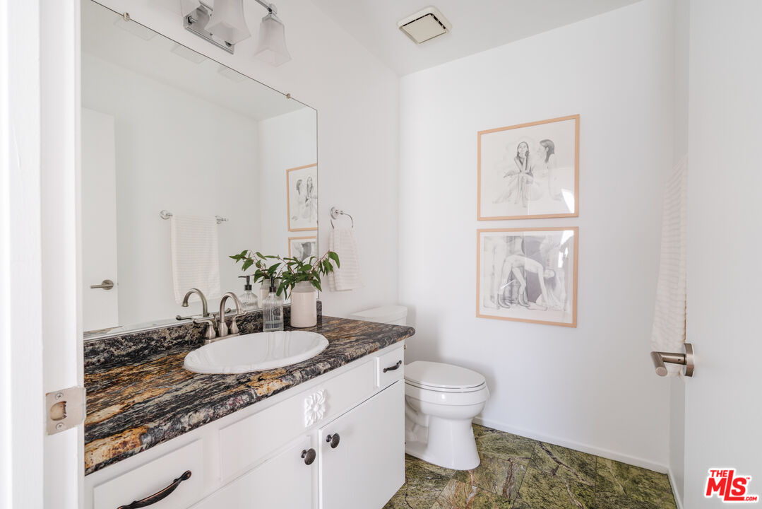11106 Arminta Street, Unit 4 Sun Valley, CA 91352 - Photo 10 of 22 a bathroom with a granite countertop sink toilet and shower
