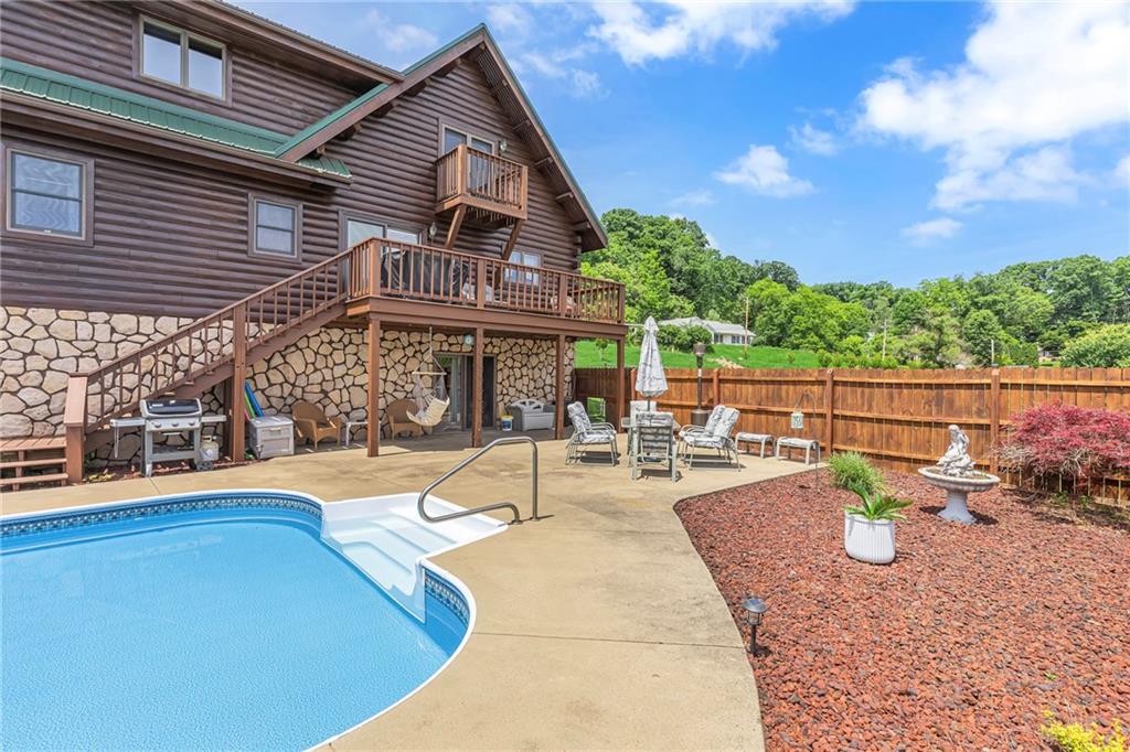 303 Sharon Grange Road Aliquippa, PA 15001 - Photo 39 of 50 Great photo featuring the pool area, two decks and access to the lower level family room with full bath.