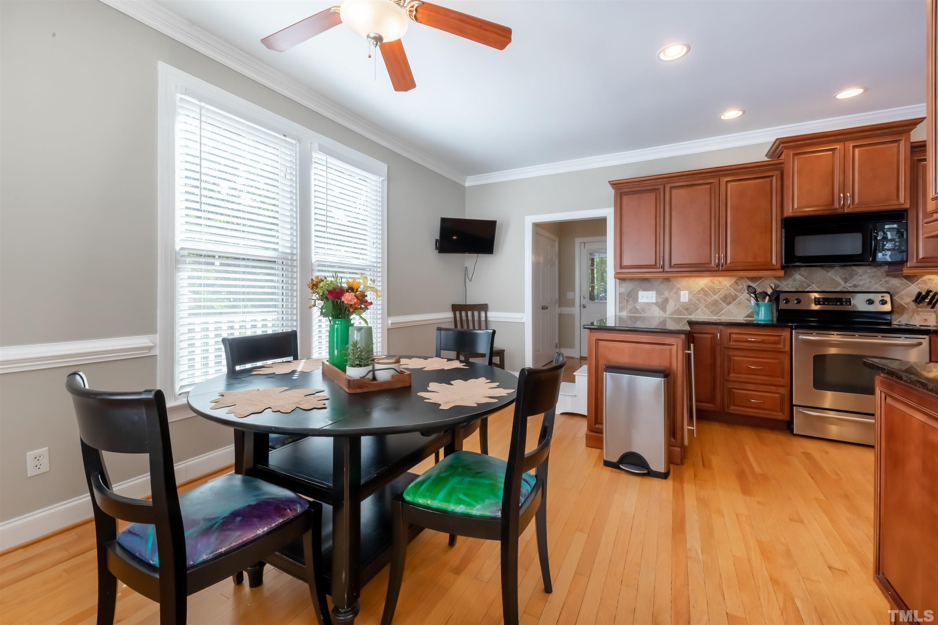 11308 Derby Lane Raleigh, NC 27613 - Photo 11 of 42 a view of a dining room with furniture and wooden floor