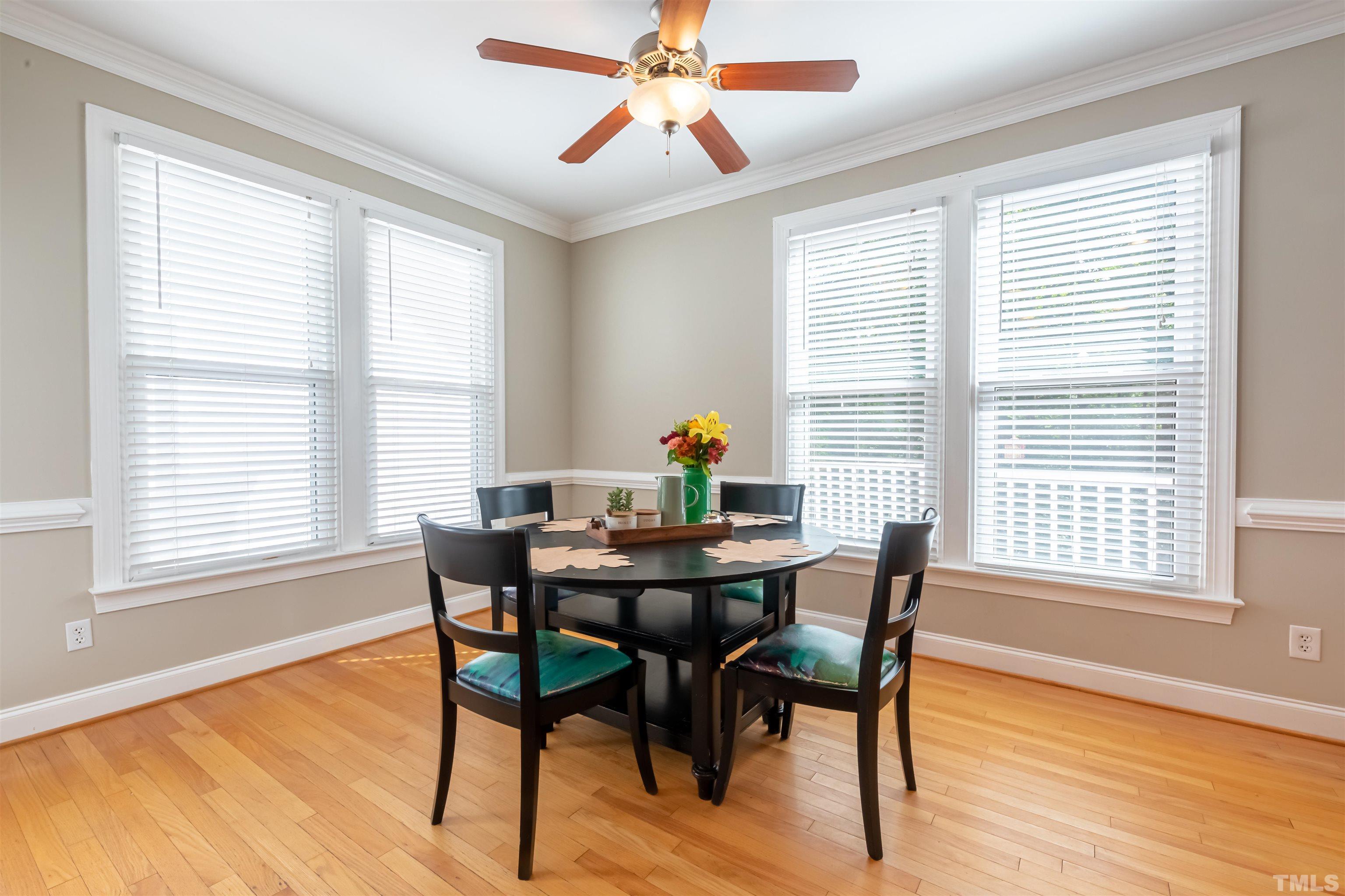 11308 Derby Lane Raleigh, NC 27613 - Photo 12 of 42 a dining room with furniture a chandelier and wooden floor