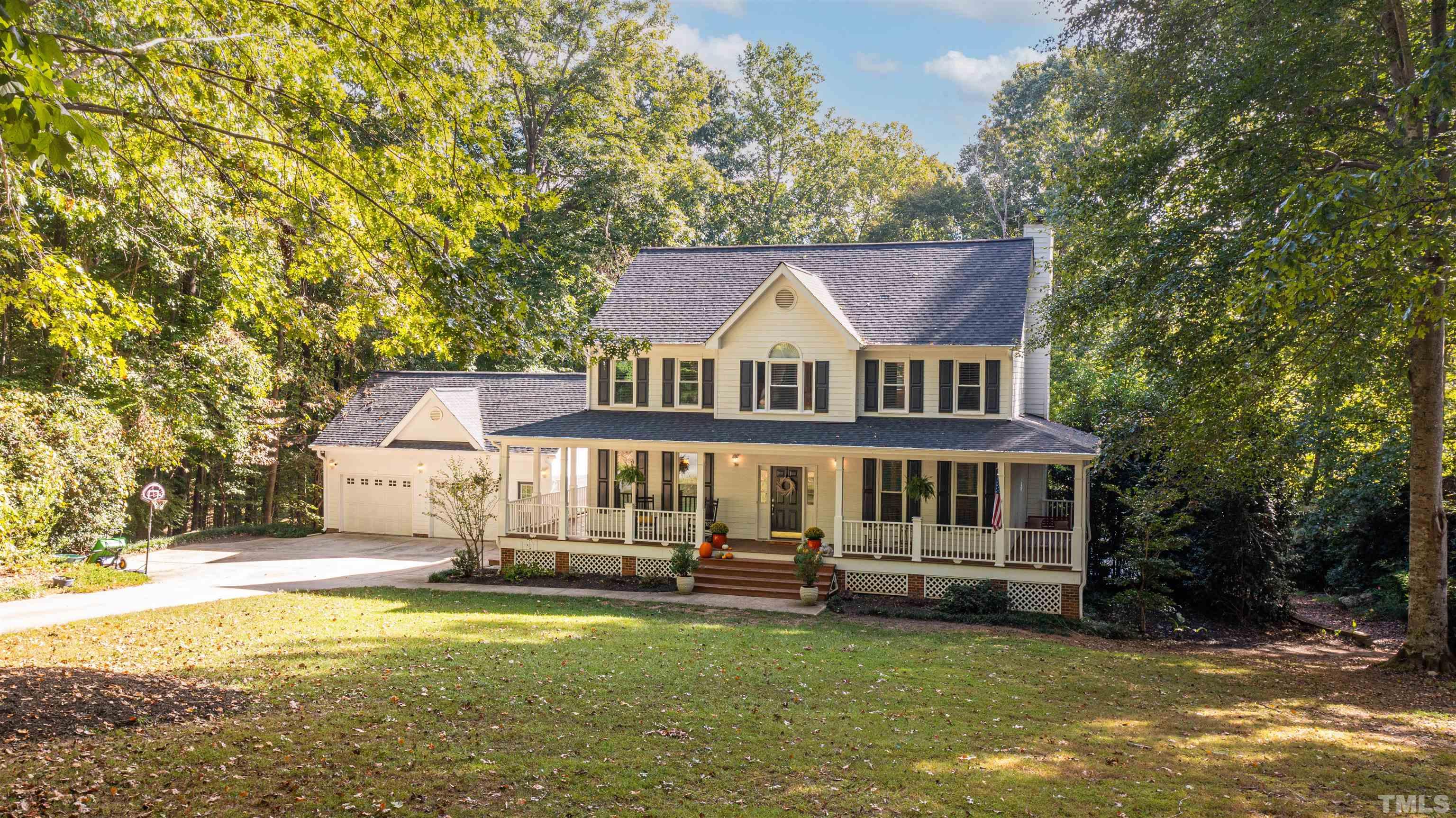 11308 Derby Lane Raleigh, NC 27613 - Photo 2 of 42 a front view of a house with a yard table and chairs