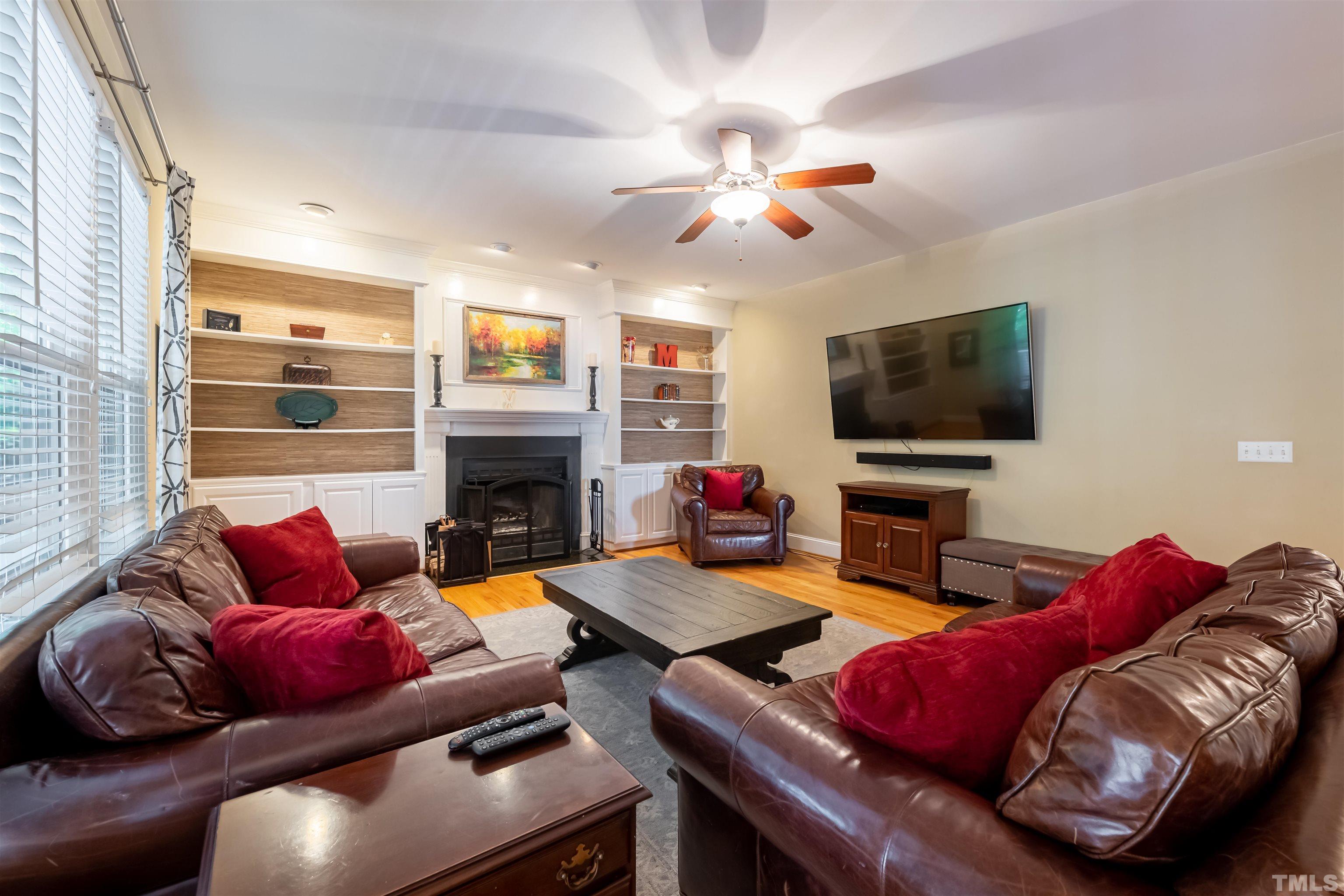 11308 Derby Lane Raleigh, NC 27613 - Photo 21 of 42 a living room with furniture fireplace and flat screen tv