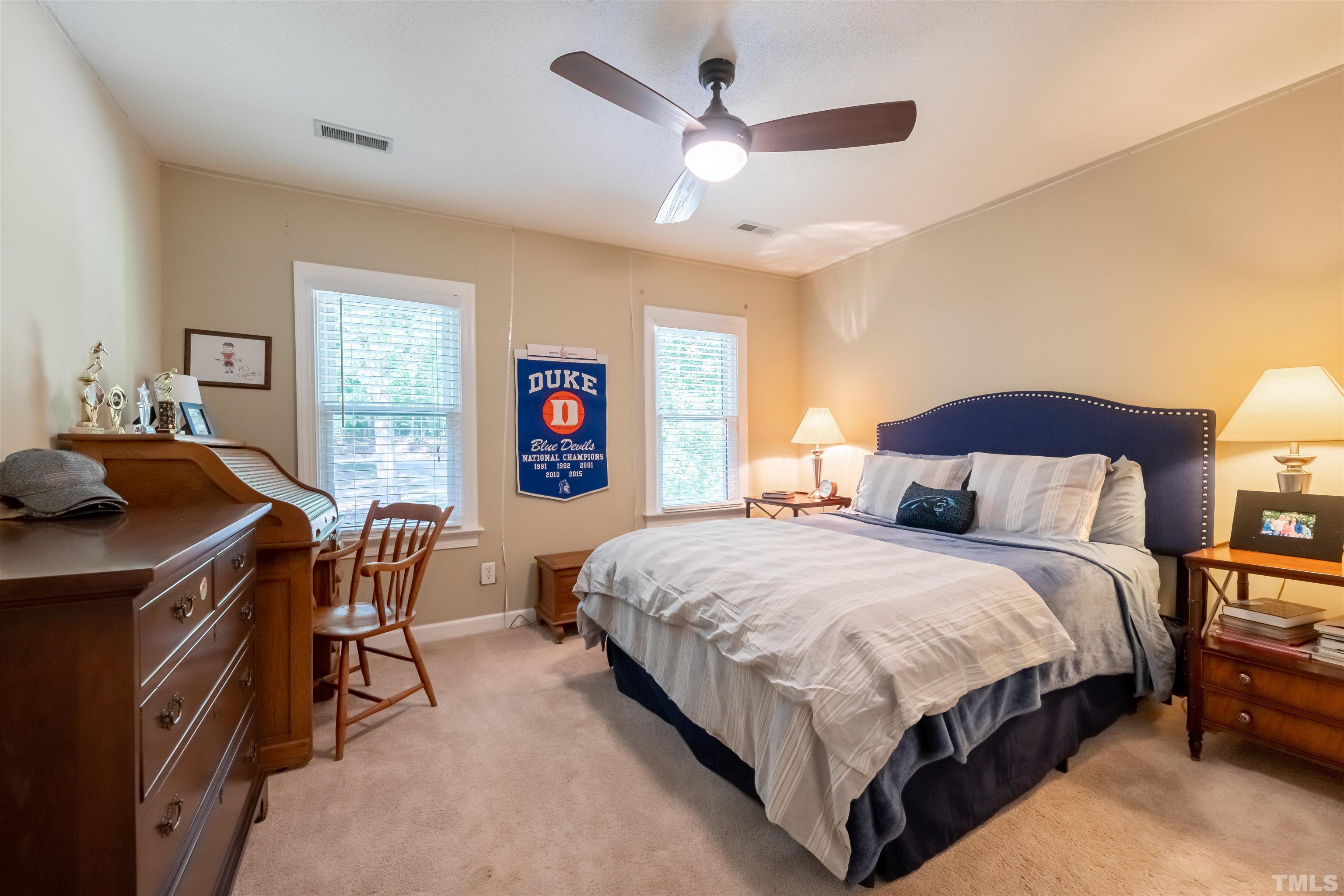 11308 Derby Lane Raleigh, NC 27613 - Photo 25 of 42 a bedroom with a bed and a table with chair
