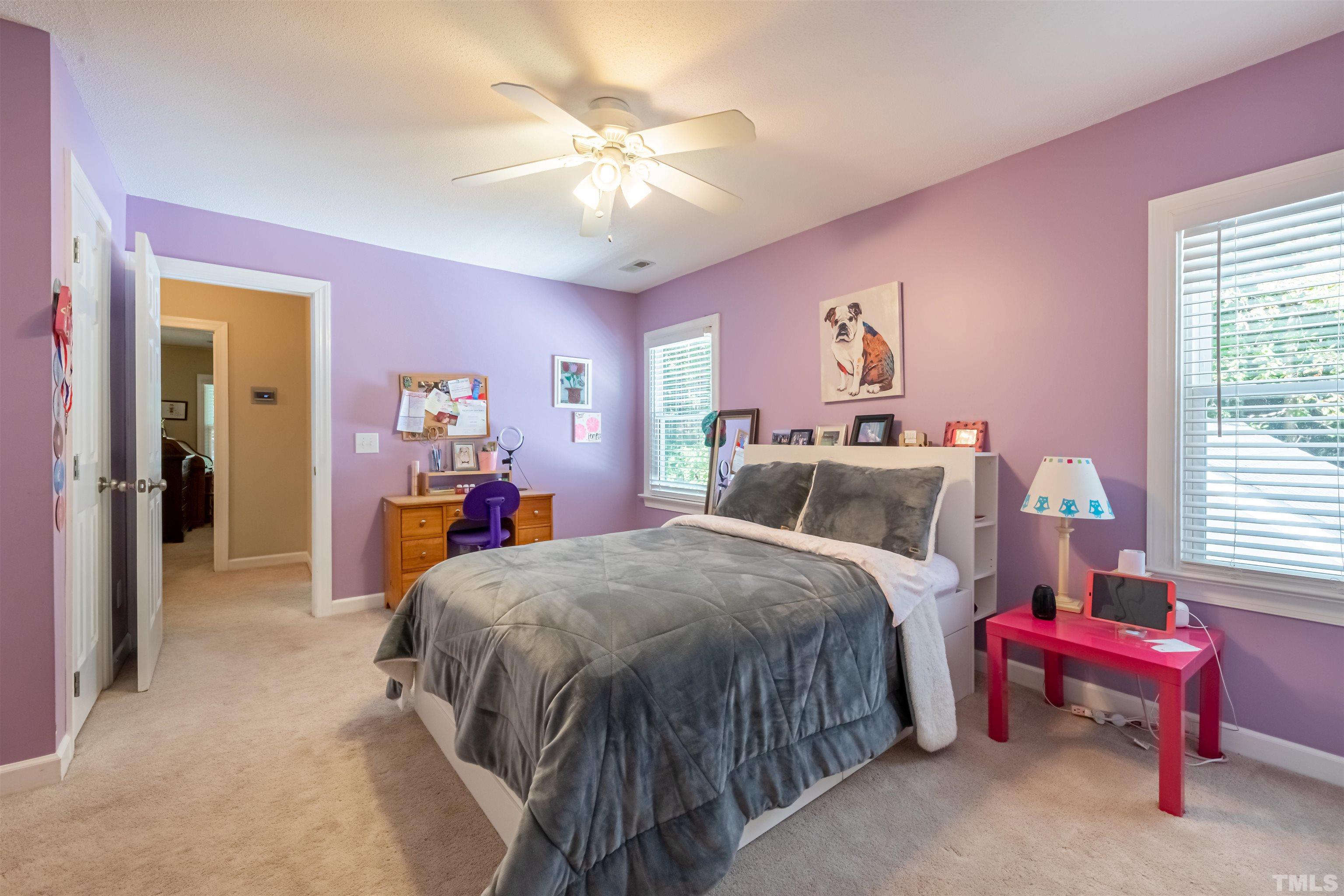 11308 Derby Lane Raleigh, NC 27613 - Photo 26 of 42 a bed room with a bed and a chandelier