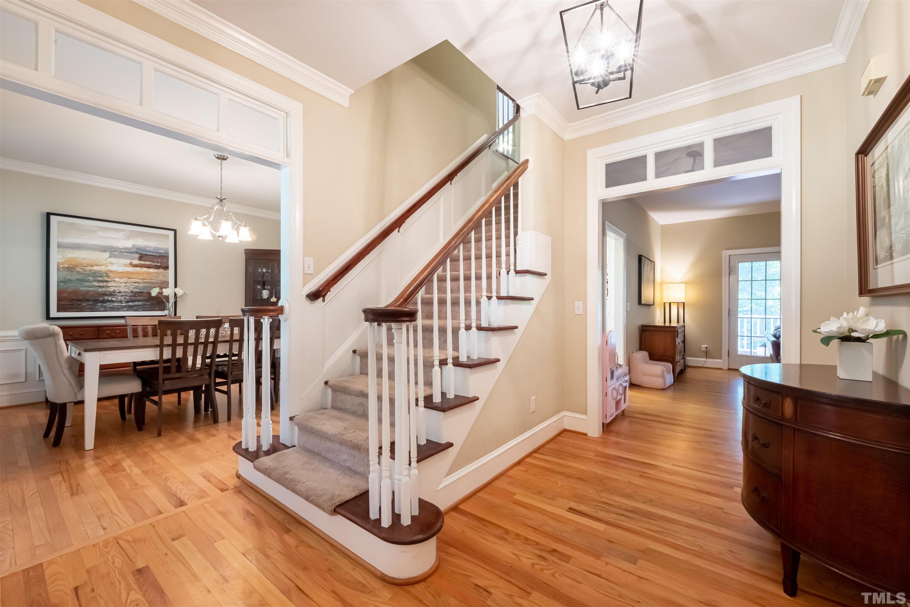 11308 Derby Lane Raleigh, NC 27613 - Photo 3 of 42 a view of staircase and living room with wooden floor