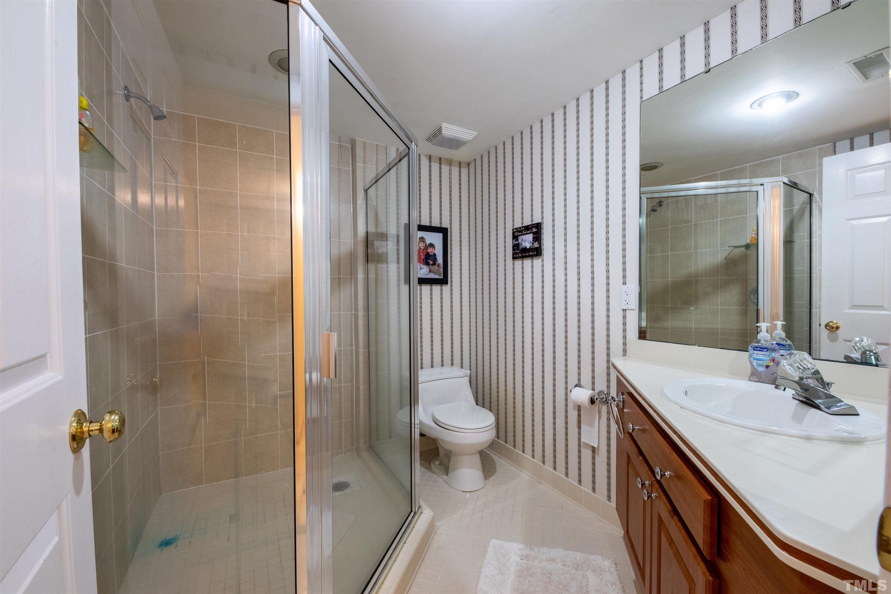 11308 Derby Lane Raleigh, NC 27613 - Photo 32 of 42 a bathroom with a sink a toilet and shower