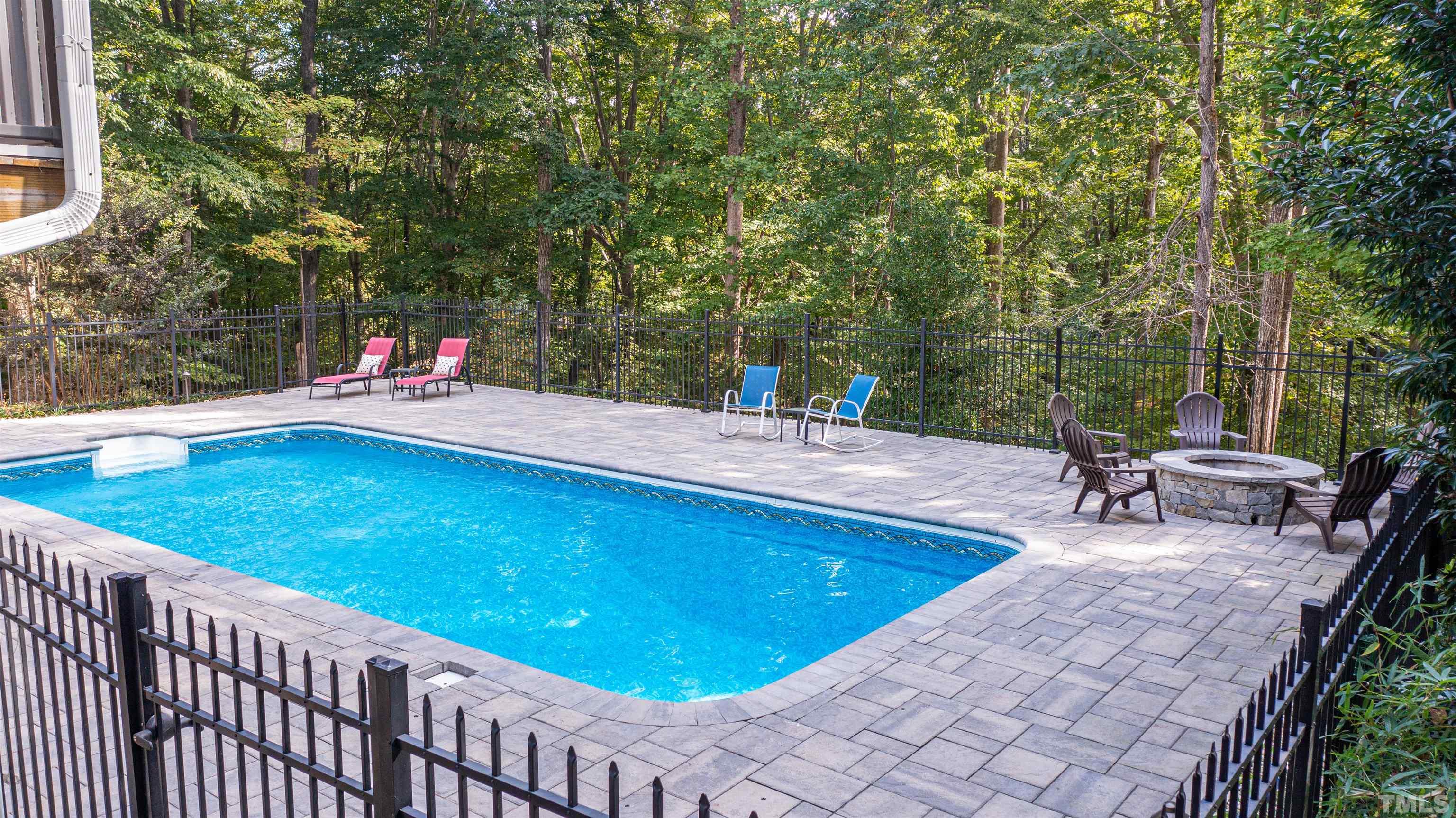 11308 Derby Lane Raleigh, NC 27613 - Photo 36 of 42 a swimming pool with lawn chairs and large trees